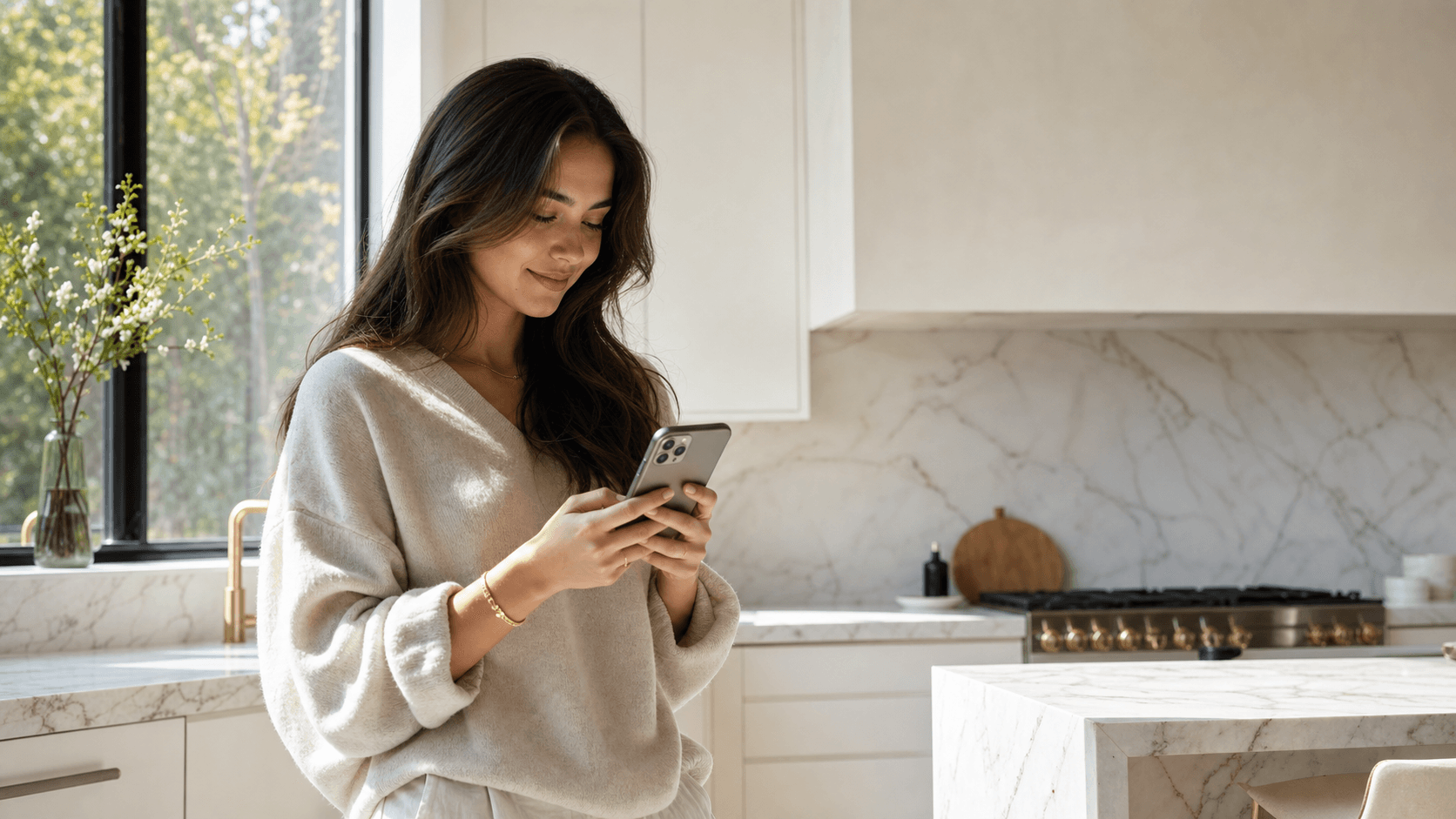 Hero product shot — a woman holding her phone mid-text with Cal, warm daylight, full-bleed (real, unposed)